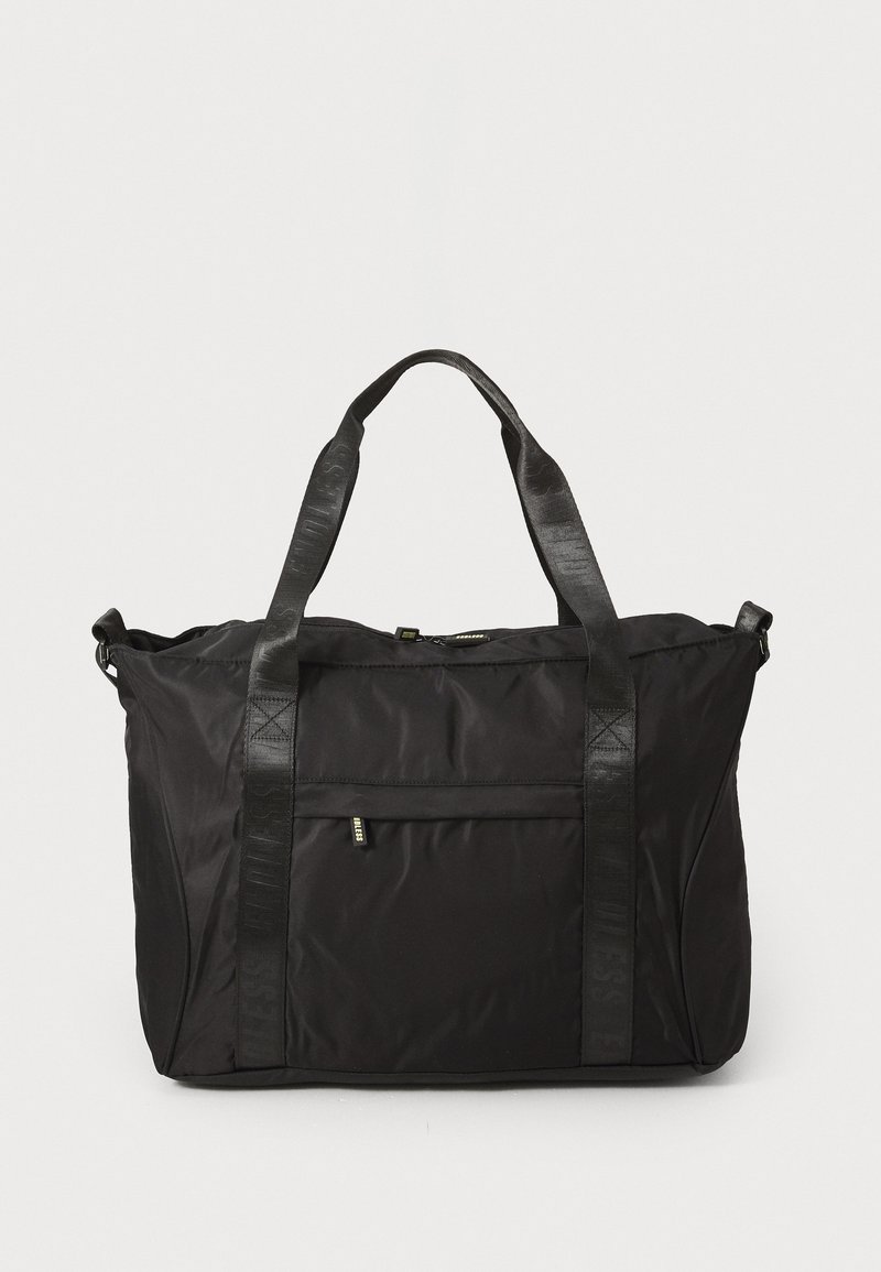 Black nylon tote bag with two textured straps, a front pocket, and subtle logo detail. Features a structured shape and durable finish.