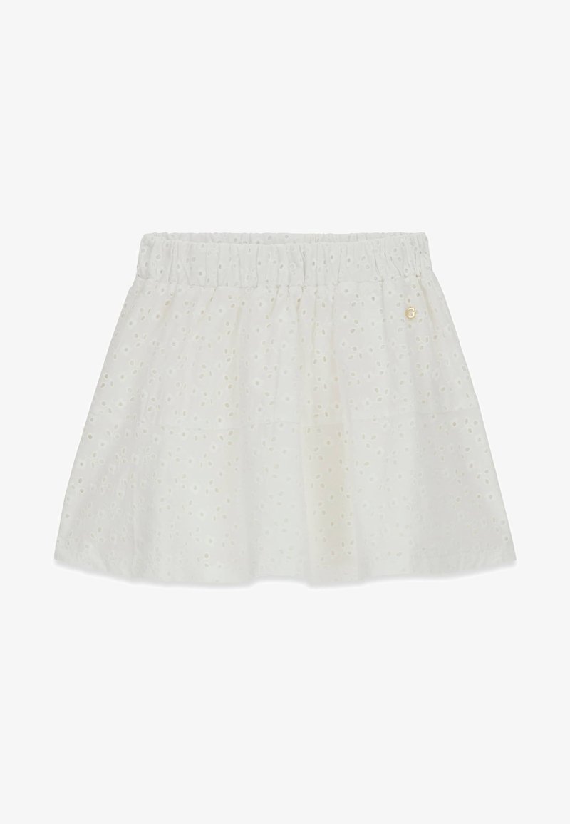 Jupe en coton blanc avec broderie anglaise, taille élastique et petit emblème doré sur le côté supérieur droit.