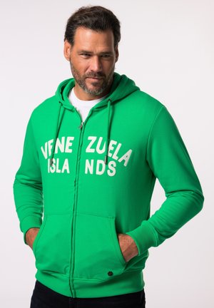 Green zip-up hoodie made of soft fabric, featuring a large white text print "VENEZUELA ISLANDS" and kangaroo pockets.