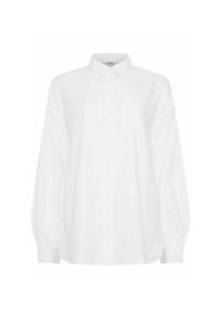 Camicia bianca con colletto, maniche lunghe e una tasca anteriore. Realizzata in tessuto morbido con una vestibilità rilassata e polsini arricciati.