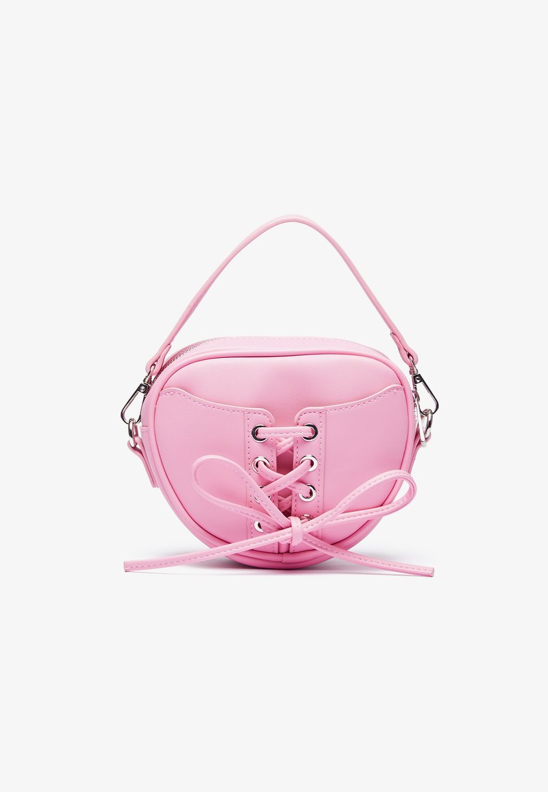 Pink faux leather handbag with a circular shape, featuring lace-up design with metallic eyelets and a bow detail. Includes a short handle.