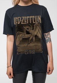 Black cotton t-shirt featuring a graphic print of a winged figure, with "LED ZEPPELIN" and "EST 1968" text in gold tones.