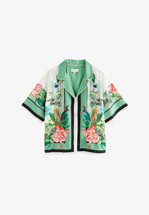 Short-sleeve shirt in light green silk, featuring vibrant floral and animal prints, black accents, and a contrasting collar and button placket.