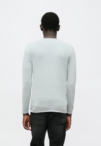 Camisola de manga comprida cinza claro com decote redondo e superfície texturizada. Apresenta costuras contrastantes ao longo das costuras. Design ajustado.