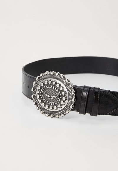 Black leather belt featuring a large silver circular buckle with beaded detailing and engraved design in the center.