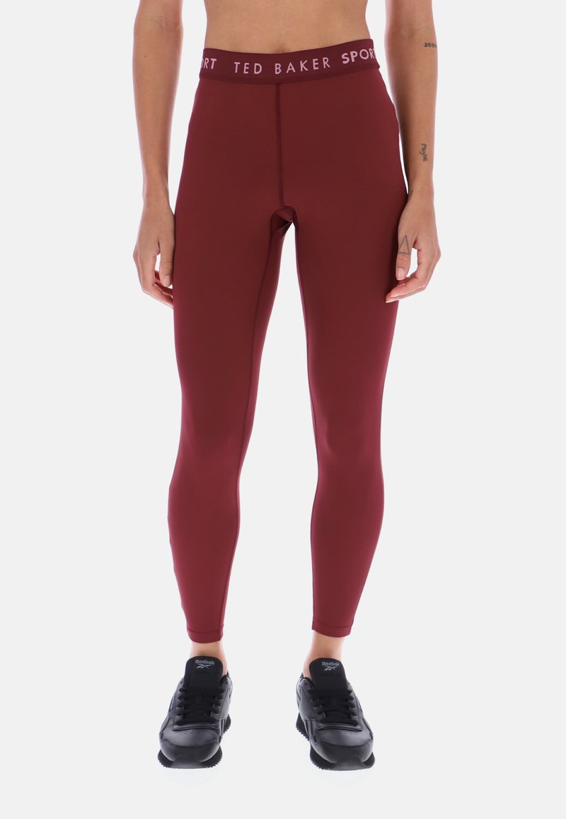 Bordowe legginsy sportowe z wysokim paskiem z napisem "TED BAKER SPORT" w kontrastującym kolorze; gładki, dopasowany fason.