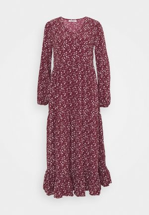 Long-sleeve burgundy dress with white small floral pattern, round neckline, gathered waist, and ruffled hem.