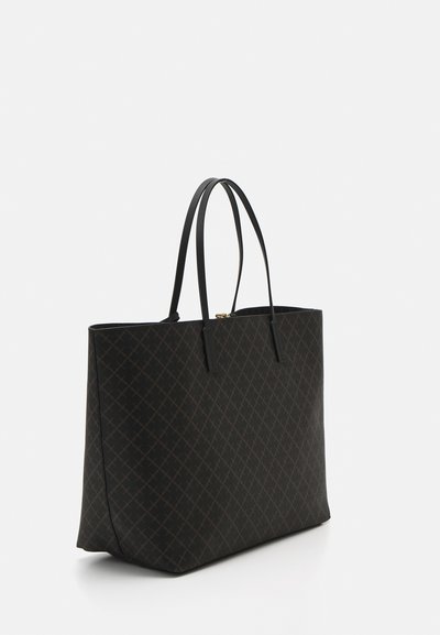 Large black tote bag made of textured material, featuring long flat handles and a subtle crosshatch pattern. Gold hardware at the top.