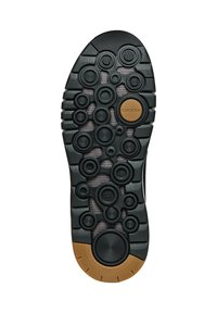 Suola di scarpa in gomma nera con motivi circolari, accenti marroni a contrasto e una superficie texturizzata per la presa e la traspirabilità.