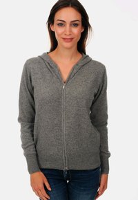 Hoodie à fermeture éclair grise avec une fermeture à l'avant, des manches longues et une capuche. Fabriqué en tissu doux et texturé. Design simple sans motifs ni accents.