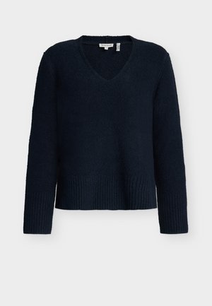 Tumesinine sviiter V-kaeluse kujundusega, pikkade varrukatega ja sooniku servaga. Valmistatud pehmest, tekstuuriga kangast.