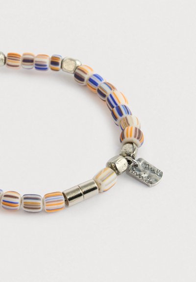 Gyöngyös karkötő hengeres, kék, narancssárga és barna csíkos gyöngyökkel, ezüst elválasztókkal és egy kis ezüst cégérrel, fehér háttéren.