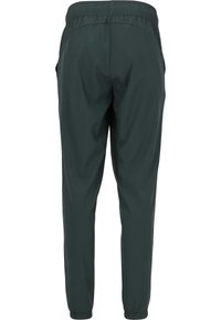 Mörkgröna joggingsbyxor med smal passform, elastisk midja och sidofickor. Slät textur och elastiska muddarna vid vristerna.