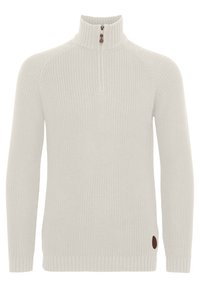 Vaaleanharmaa neulottu paita korkealla kauluksella ja puolikkaalla vetoketjulla. Päällä on resorit hihansuissa ja helmassa, sivussa pieni ruskea logoplaatti.