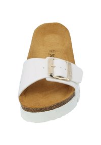 White slide sandal with a wide strap and gold buckle, cork footbed, textured tan insole, and a thick white sole.