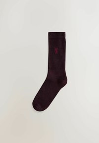 Burgundy ribbed sock made of soft fabric, featuring a small embroidered logo near the top. Classic shape with a slightly stretchy cuff.