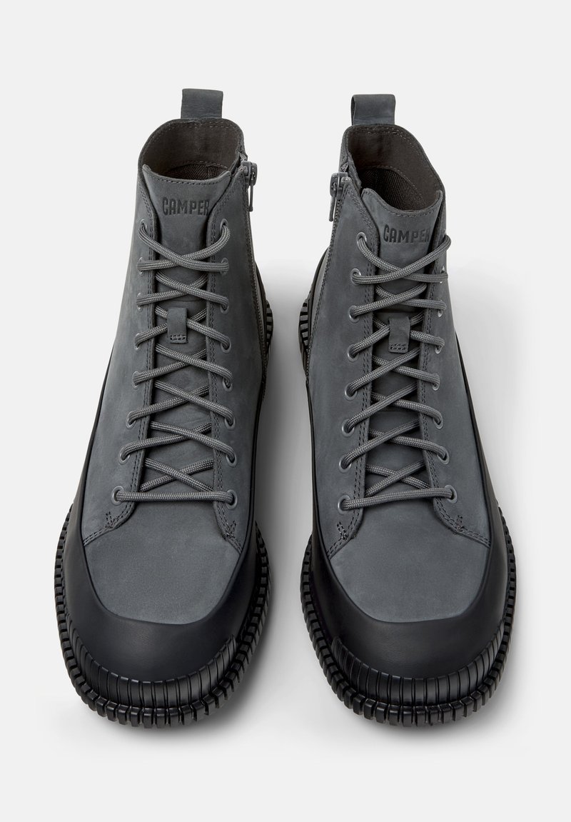 Gray high-top shoes with smooth leather upper and rubber sole. Features laces and side zip for closure. Textured rubber accents at sole.