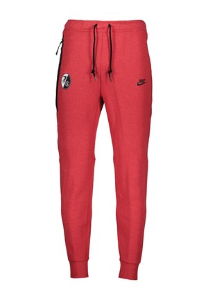 Pantaloni della tuta Nike rossi con laccetti neri, tasca laterale con zip e patch con logo nero e bianco sulle cosce.