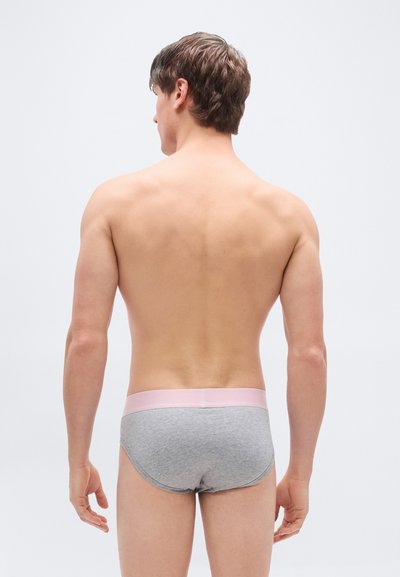 Sive bombažne spodnjice z mehkim roza pasom, minimalističnim dizajnom, prilegajočim se krojem in gladko teksturo, videti od zadaj.