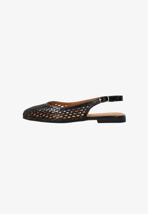 Zwarte platte slingback schoen met honingraat uitsnijdingspatroon en een kleine zilveren gesp op het bandje.
