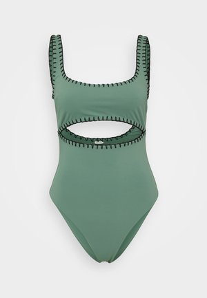 Žalias vienos dalies maudymosi kostiumėlis su kvadratiniu kaklu, juodais siuvinėjimo akcentais ir išpjova liemens srityje. Lygus audinio paviršius.