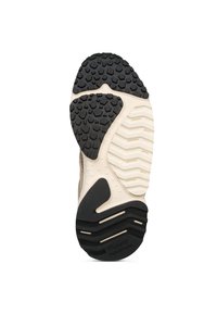 Suola di sneaker con una sezione in gomma nera testurizzata, intersuola beige con un motivo ondulato e un distintivo dettaglio di branding.
