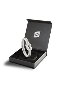 White braided leather bracelet displayed in a black box with a soft interior. Features a silver clasp and a knot detail. Box has logo.