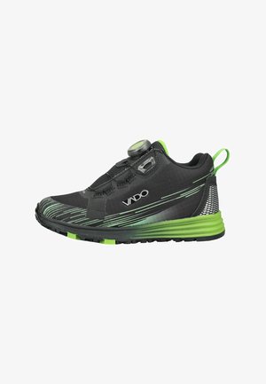 Schwarzer und grüner Sportschuh mit strukturierter Sohle, Drehverschlusssystem und grünem Zuglasche an der Ferse.