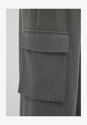 Pantalones a rayas grises con un gran bolsillo de cargo en el lateral, confeccionados en una suave tela texturizada y con un sutil detalle amarillo en las rayas.