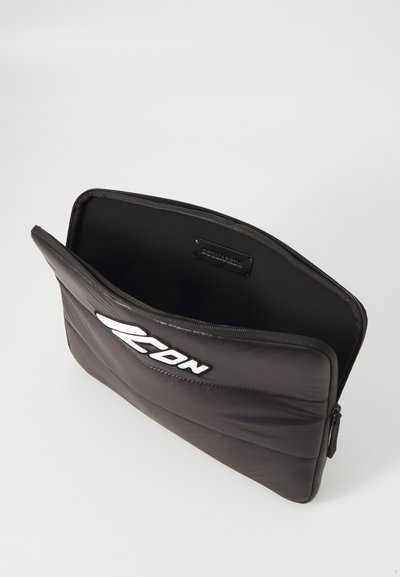 Custodia per laptop nera imbottita con chiusura a zip, caratterizzata da un logo bianco, texture liscia e forma rettangolare. L'interno non è foderato.