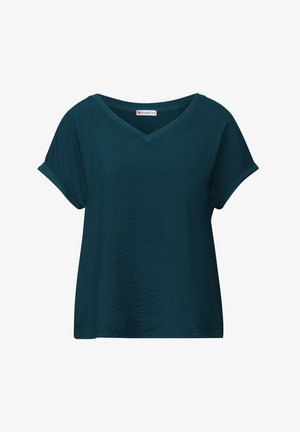 Camiseta de cuello en V en color azul verdoso con mangas cortas enrolladas, con una superficie texturizada y un ajuste informal. Etiqueta de la marca Street One visible en el interior.