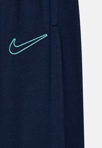 Nike Performance ACADEMY 23 PANT BRANDED UNISEX - Pantalones deportivos - midnight navy/hyper turq