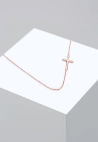 Rose-guldkæde med en minimalistisk korsanhæng på en delikat kæde med runde led. Glat overflade og slank design.