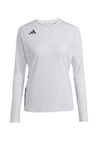 Majica dugih rukava sportskog kroja od bijele tkanine, s okruglim izrezom i crnim Adidas logotipom na lijevom ramenu i bočnom detalju.