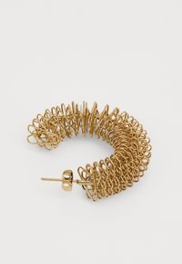 Goldene Spiral-Haarschmuck mit einer gewundenen Form, ausgestattet mit einem sicheren Metallverschluss und einer glatten, schimmernden Textur.