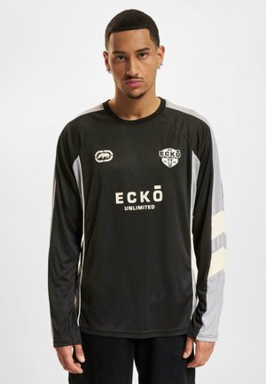 Black long-sleeve sports jersey with gray and cream accents; features "ECKŌ UNLIMITED" text and logo on the front. Smooth texture.