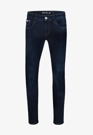 Tmavomodré úzke rifle s predným zapínaním na gombíky a zips, pútkami na opasok a dvoma prednými vreckami na bielom pozadí.