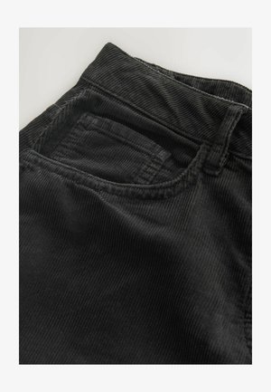 Black corduroy pants featuring a textured ribbed surface, a front pocket, and a waistband with belt loops.