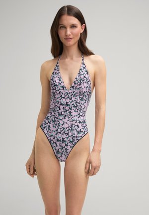 Eén stuk badpak met een diepe V-hals, halterbandjes en een bloemenpatroon in roze en groen op een zwarte achtergrond. Hoog uitgesneden beenontwerp.