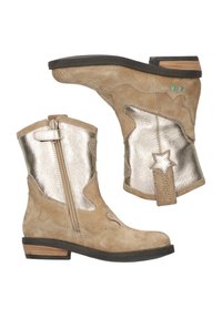 Beige suede ankle boots with silver metallic accents and star detail. Small heel, side zipper, and unique cut-out design.