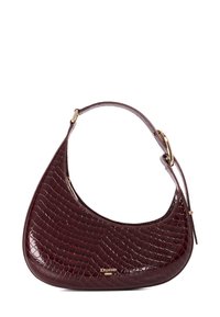 Burgundy crocodile-embossed handbag with a curved shape, gold-tone hardware, and a single adjustable strap. Features a zip closure.