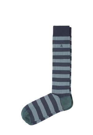 Medias hasta la rodilla con franjas alternas de verde oscuro y claro. Están hechas de un material acanalado con una banda sólida oscura en la parte superior.