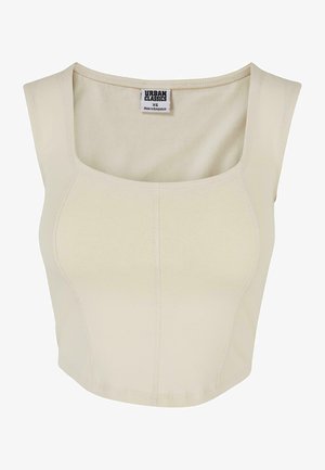 Kreemjas värvis lühike topp, mis on valmistatud pehmest kangast, ruudukujulise dekolteega, sobitatud disainiga ja minimaalsete õmblusdetailidega. Sildil on kirjas "Urban Classics."