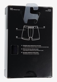 Black packaging featuring a graphic of black boxer trunks with a white "JORDAN" waistband. Includes product features in white text on a black background.