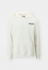 Sudadera con capucha de color crema, fabricada con un tejido suave. Presenta un bolsillo frontal, puños acanalados y un logo verde de "Converse All-Star" en el pecho.