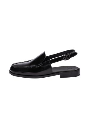 Black leather slingback loafer with a square toe, low heel, and adjustable buckle strap.