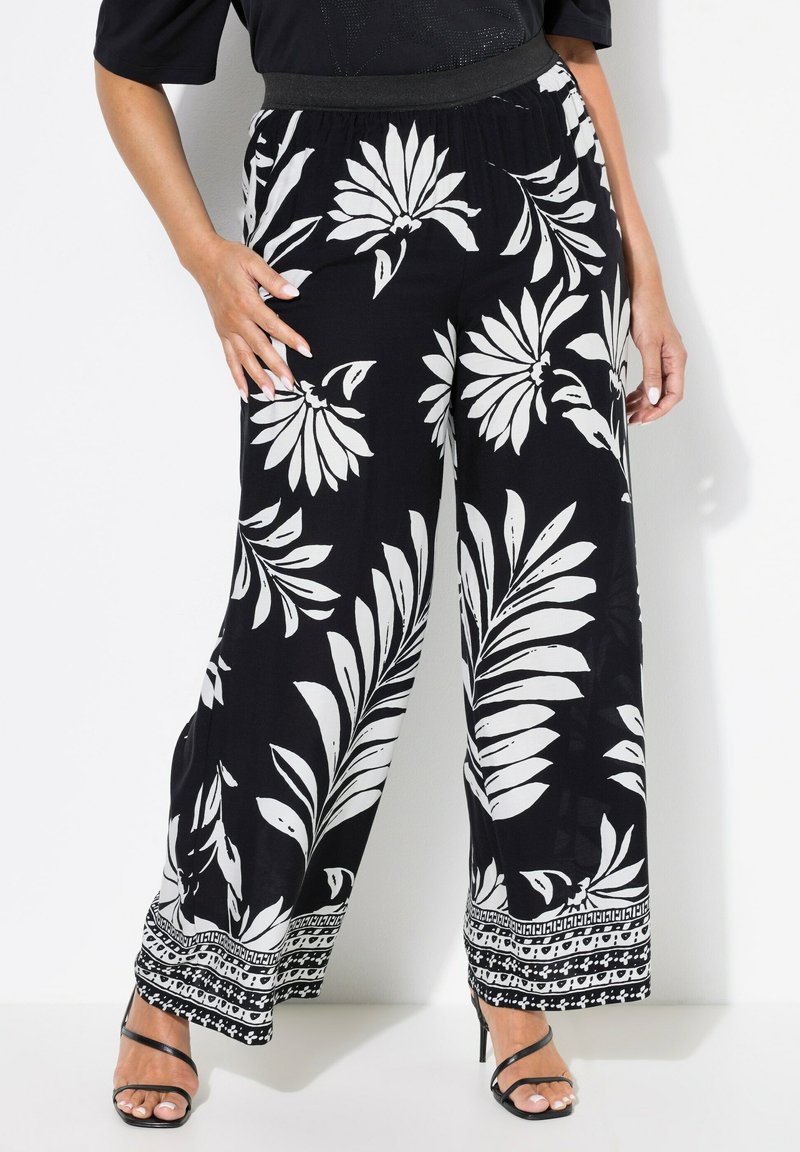 Černobílé kalhoty s květinovým vzorem a širokými nohavicemi, s elastickým pasem a kontrastním lemováním, vyrobené z lehkého materiálu.