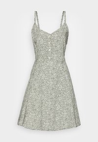 Vestido sin mangas verde con pequeño patrón floral blanco, con botones en la parte delantera, ajustado en la cintura y falda acampanada.