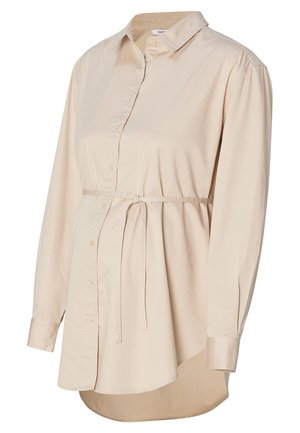 Chemise de maternité beige clair avec un devant à boutons, des manches longues, un col et une taille ajustable avec cordon. Présente un ourlet arrondi.