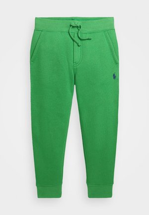 Grønne joggingbukser med snøre i taljen, sidelommer, elastiske manchetter og lille mørkeblå broderet logo på højre lår.